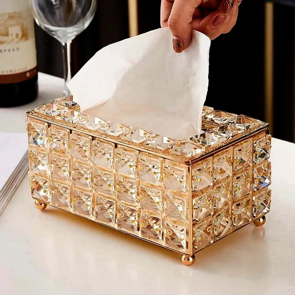 Luxury crystal tissue box with exquisite design and tissues being pulled out.