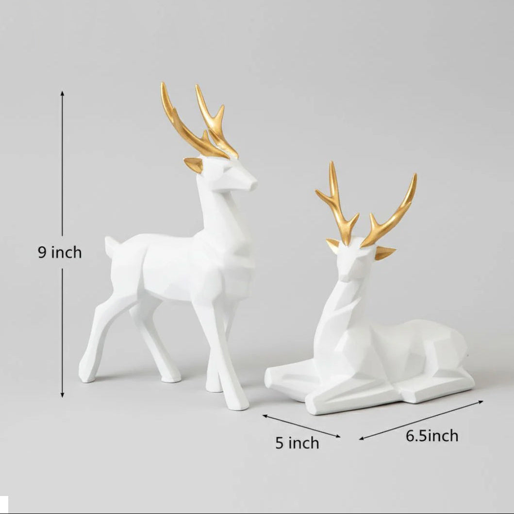 Two deer figurines with gold antlers on a gray background, showing measurements.