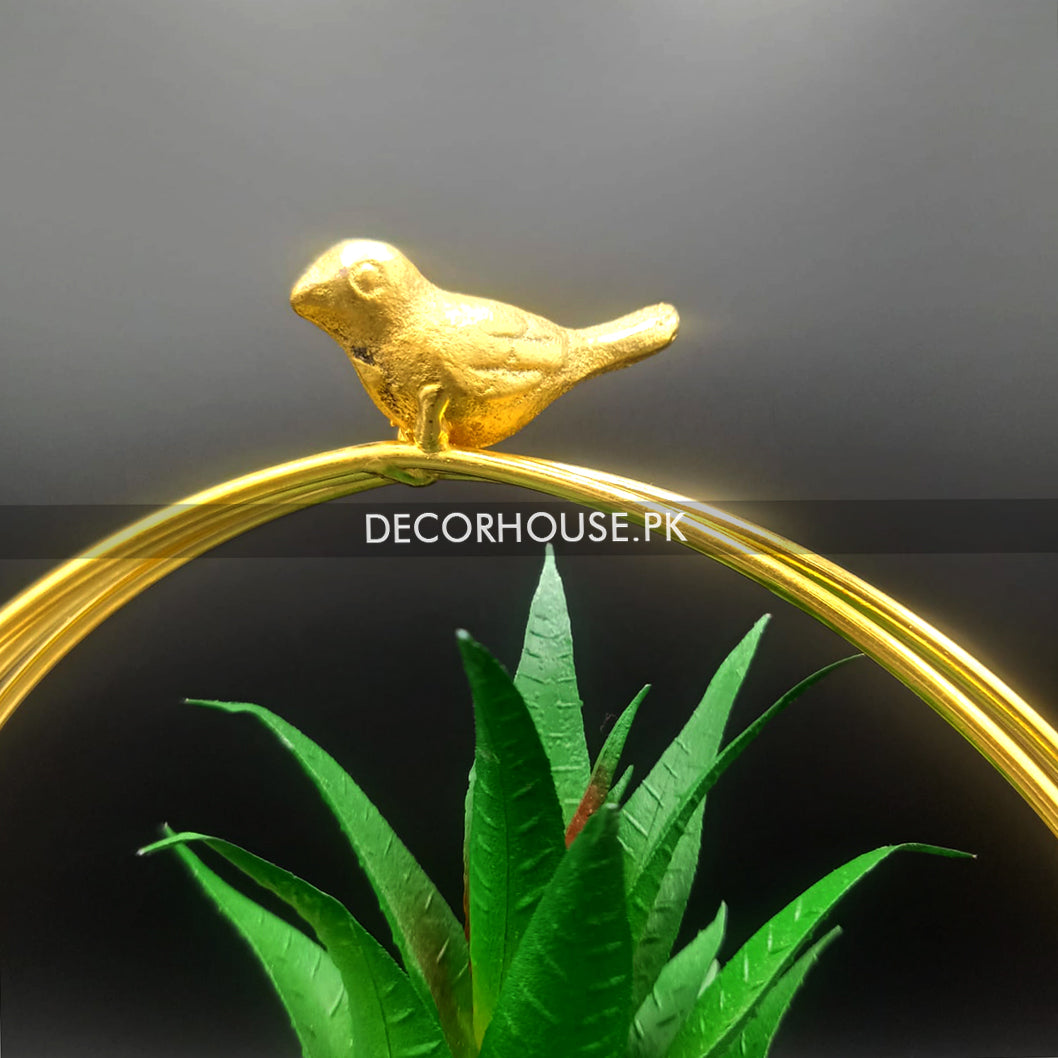 Metal geometric frame with bird and plant