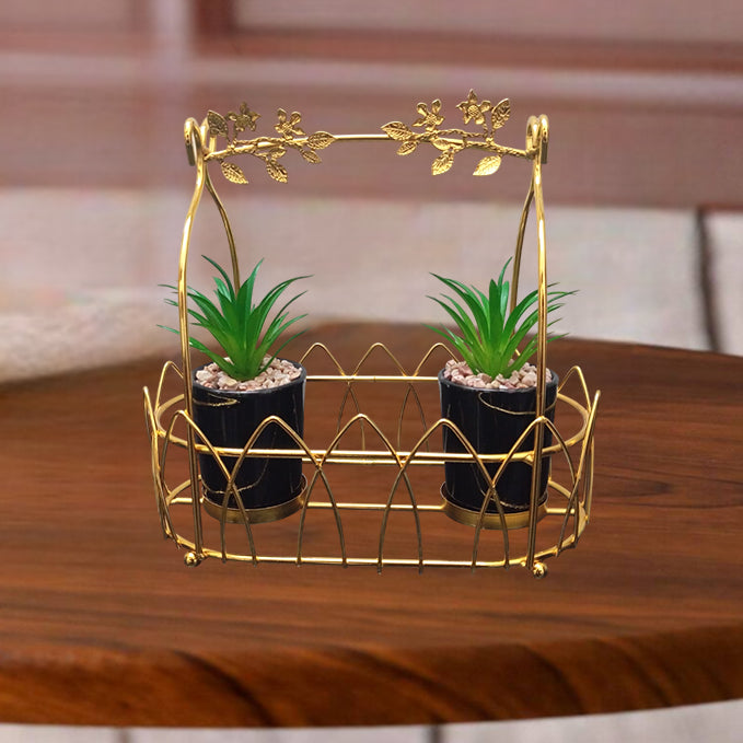 Gold decorative stand with two potted plants on a wooden surface