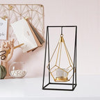Geometric candle holder with gold accents on a white surface