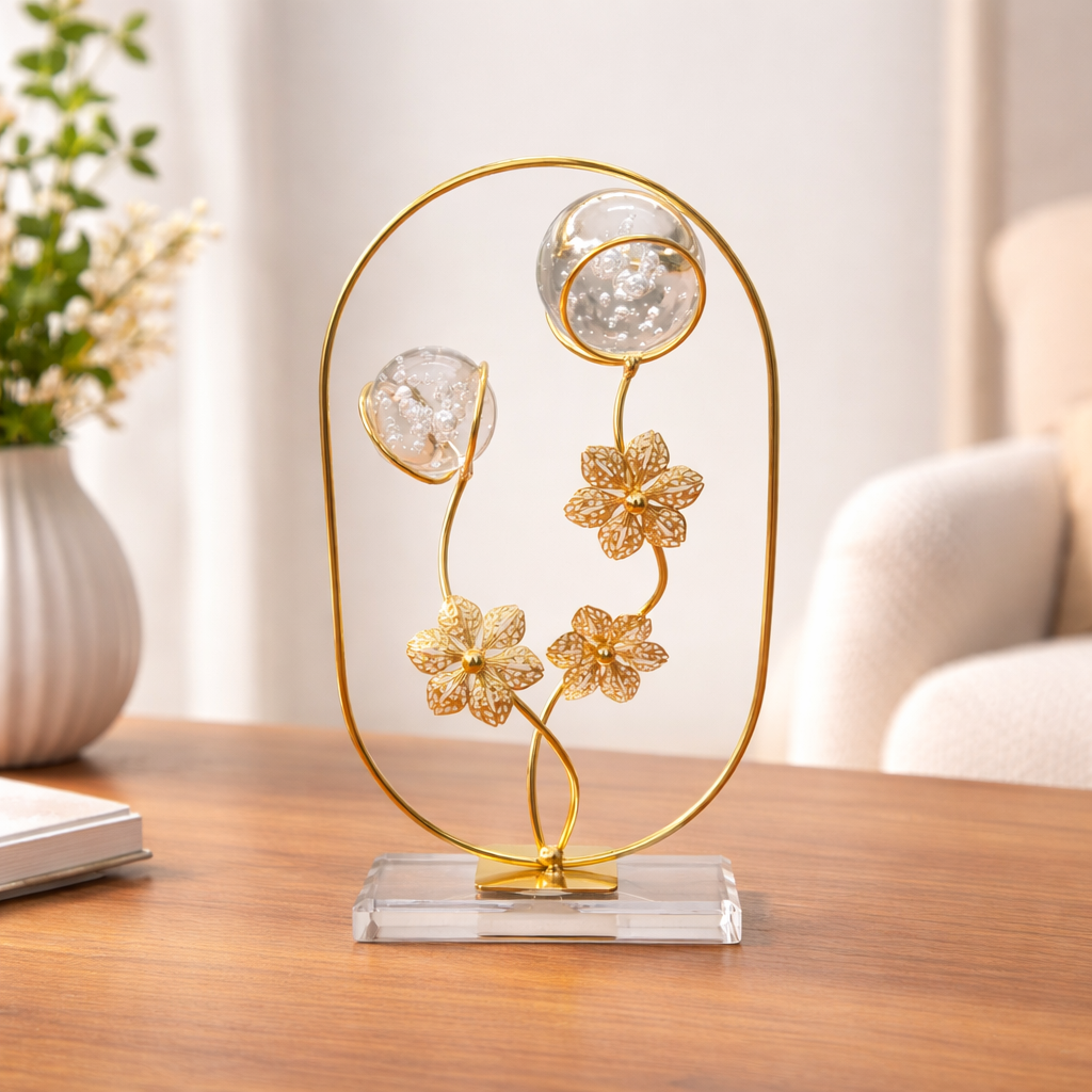 Decorative gold sculpture with crystal elements on a wooden surface