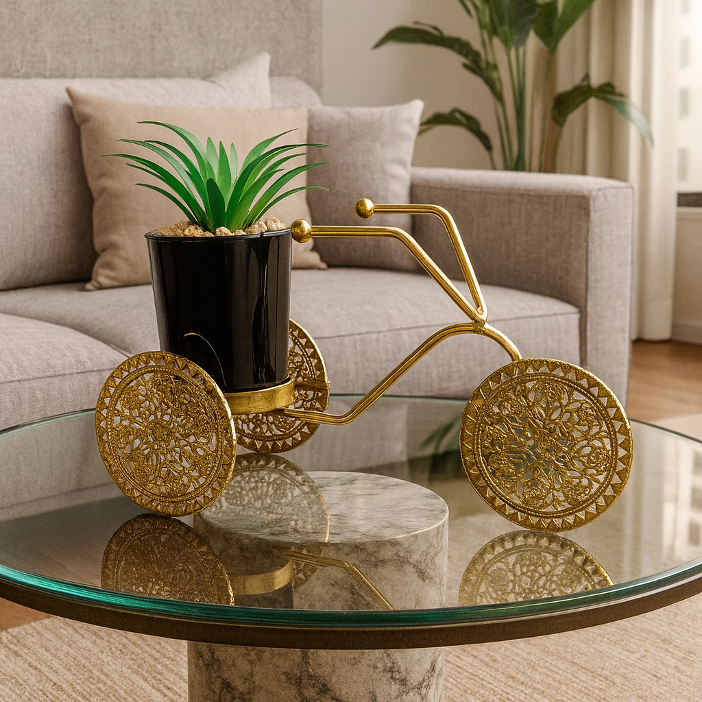 Decorative gold tricycle with a plant on a glass coffee table in a living room.