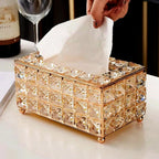 Luxury crystal tissue box with exquisite design and tissues being pulled out.
