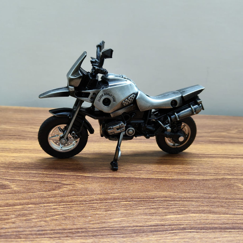 Model motorcycle on a wooden surface with a neutral background