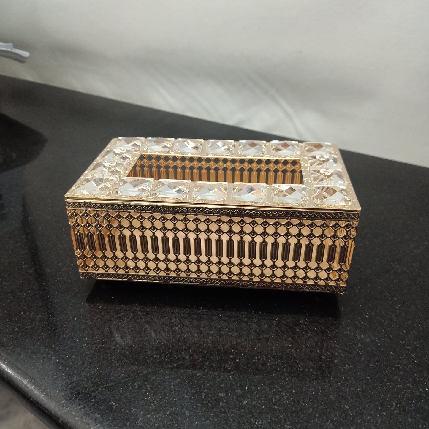 Decorative jewelry box with intricate patterns on a dark surface