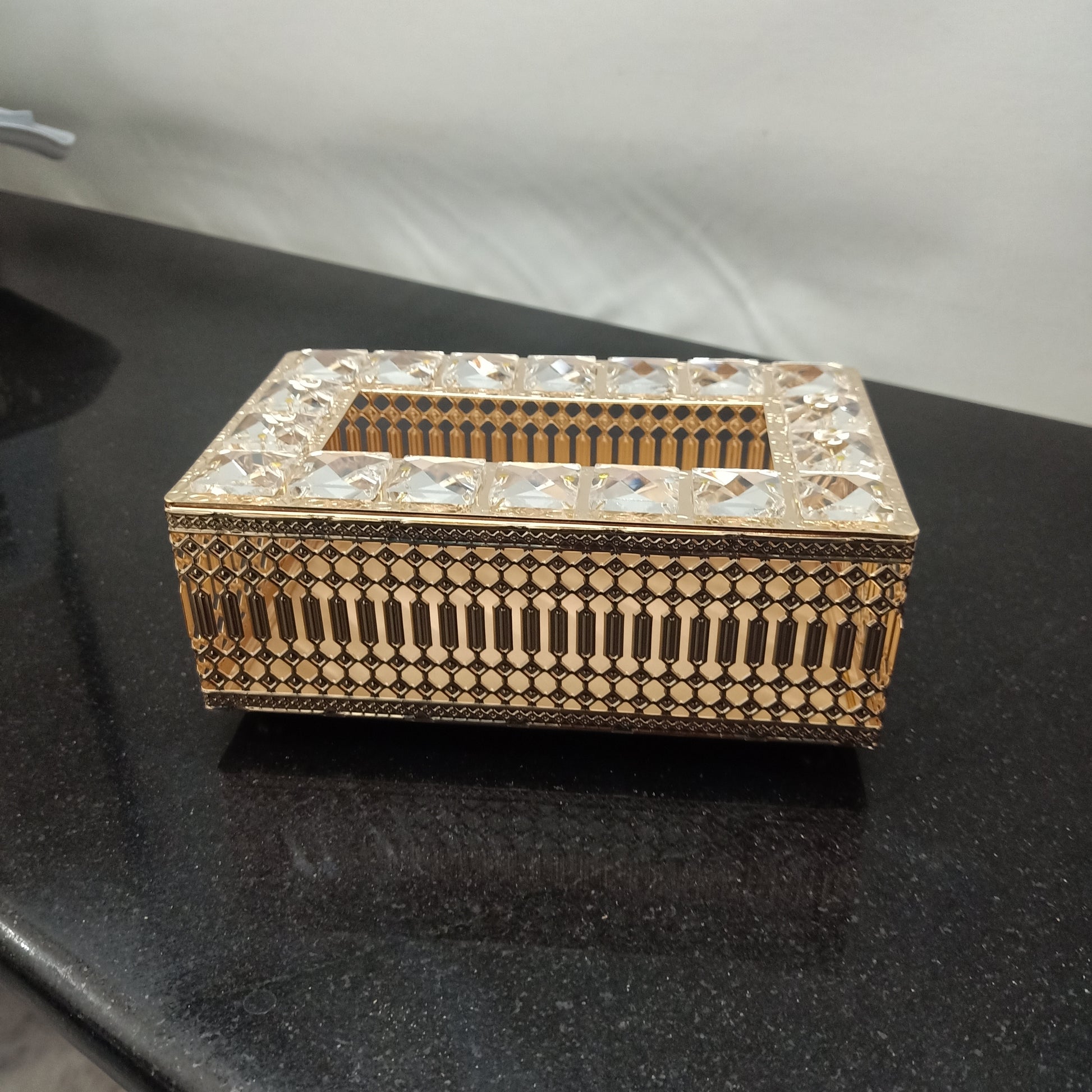 Decorative jewelry box with intricate patterns on a dark surface