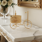 Gold decorative bicycle with a basket on a marble surface